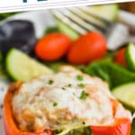 close up of a ground turkey stuffed pepper on a plate with salad in the background, says: the best turkey stuffed peppers