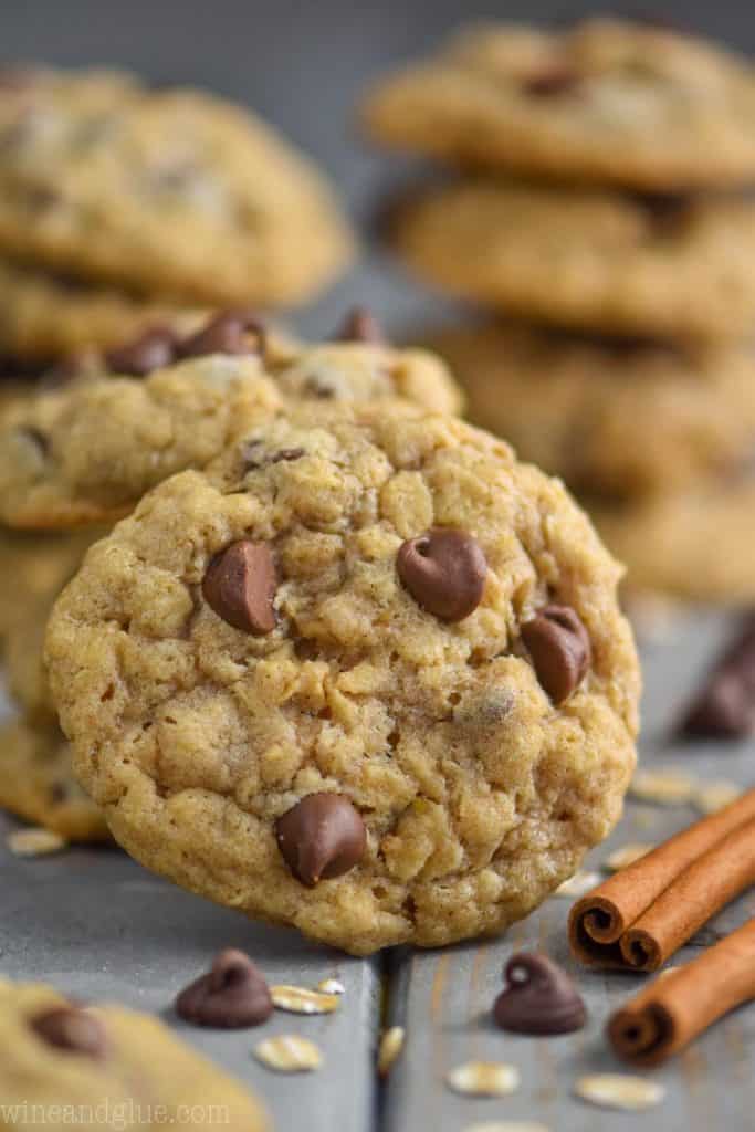 oatmeal chocolate chip cookie propped up against other cookies