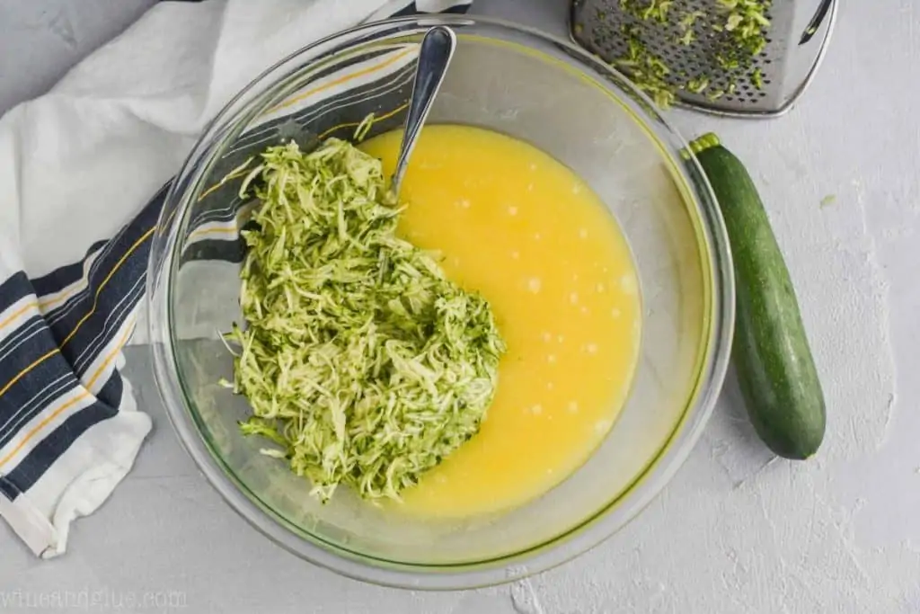 overhead view of zucchini muffin batter with shredded zucchini in it