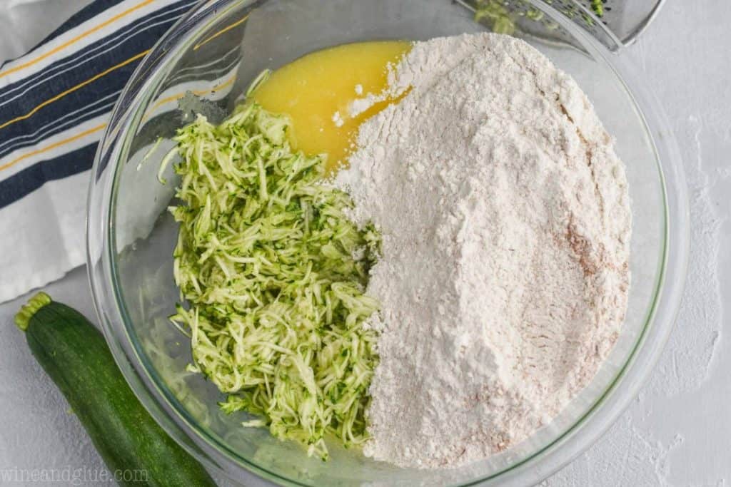 flour mixture with shredded zucchini, and oil and sugar mixture to make zucchini muffin recipe