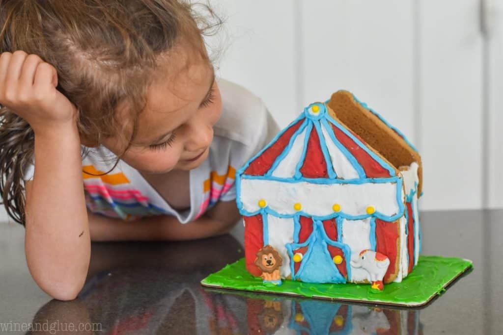 little girl looking at 3-d circus tent cookie house