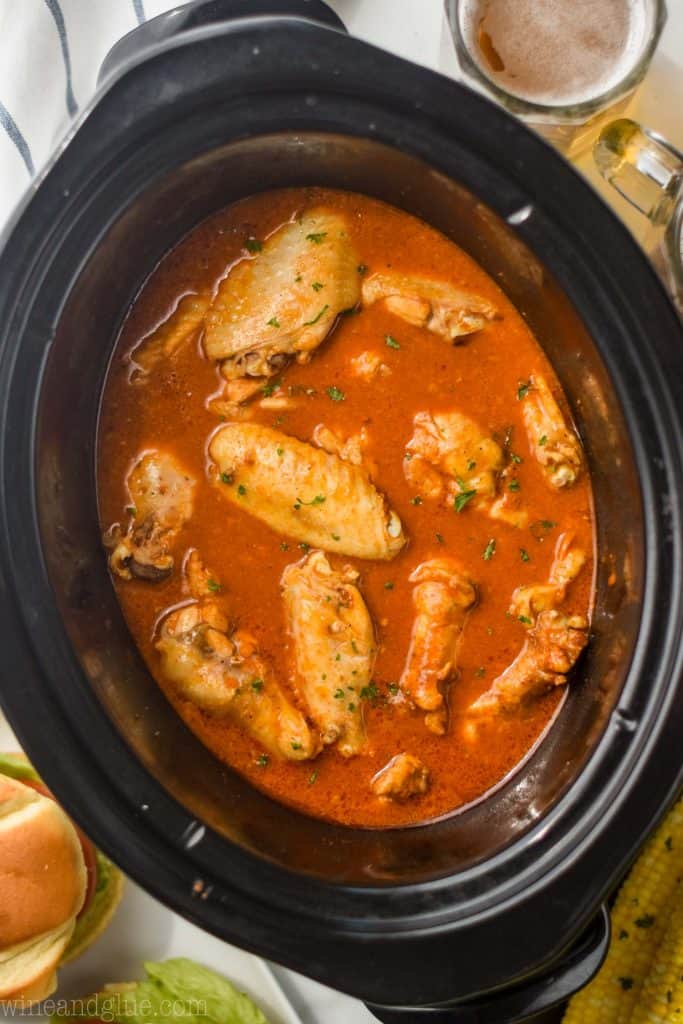 overhead view of crockpot chicken wings in crock pot after cooking from frozen