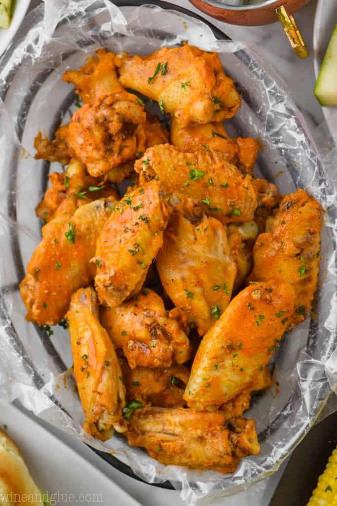 crockpot chicken wings in wax paper and a wire basket