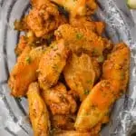 crockpot chicken wings in wax paper and a wire basket