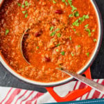 pinterest graphic of overhead view of a red stock pot with a vegetarian chili recipe and a metal ladle coming out of it, says: tried and true vegetarian chili simplejoy.com