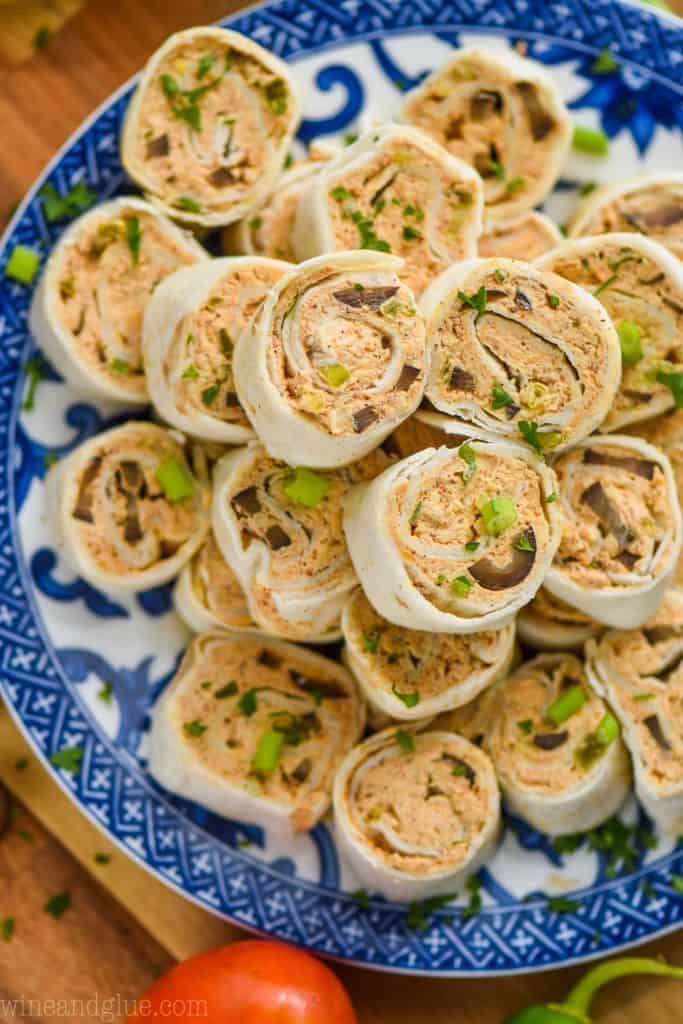 pile of taco pinwheel recipe on a blue and white patterned plate from above