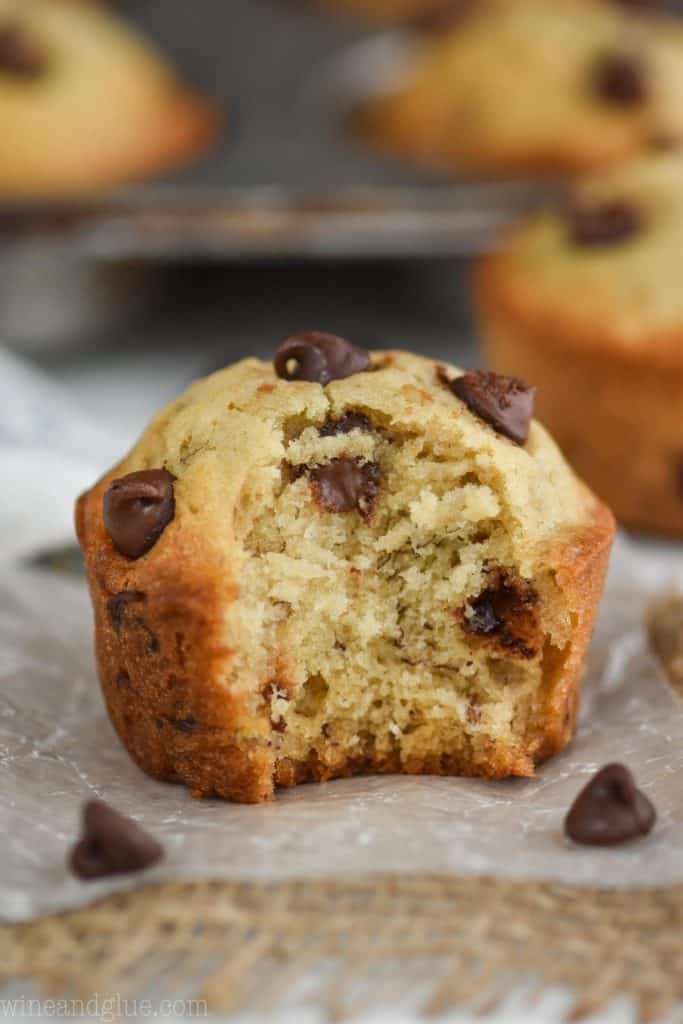 a close up of a banana chocolate chip muffin with a bite mixing