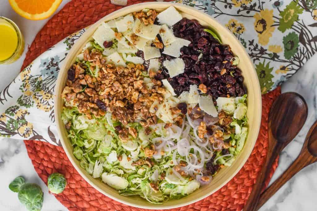 landscape photo of overhead view of brussels sprout salad recipe divided by ingredient