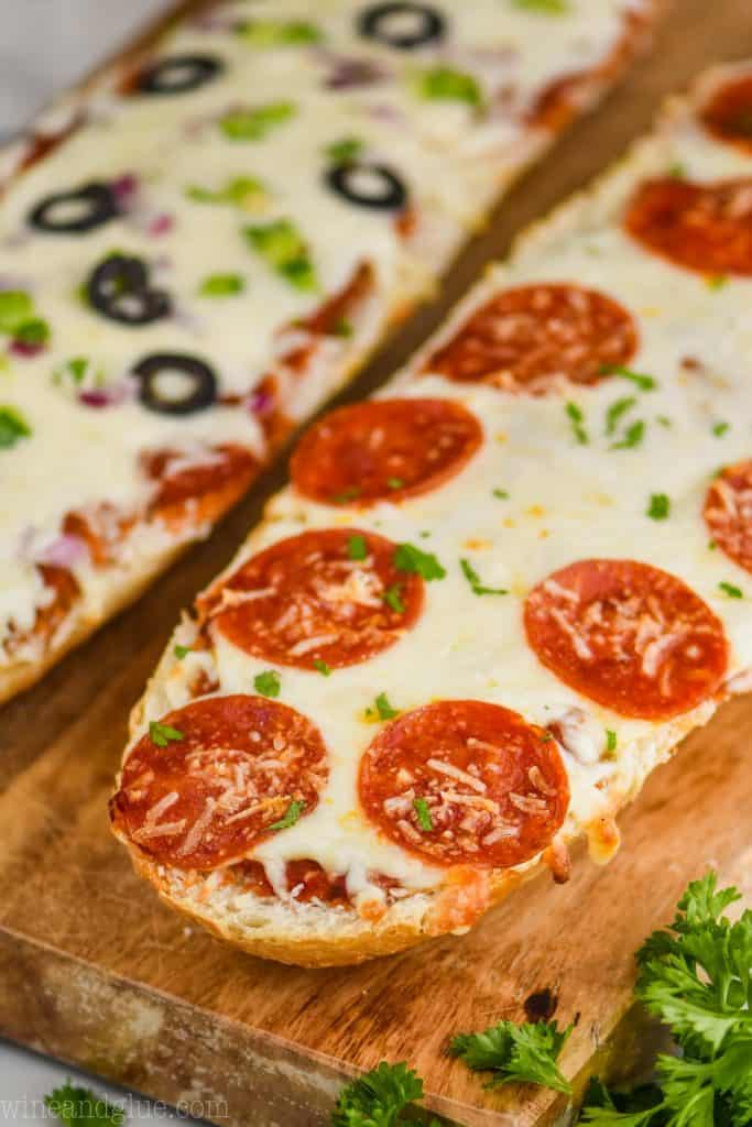 up close head on view of french bread pizza on a cutting board topped with pepperoni