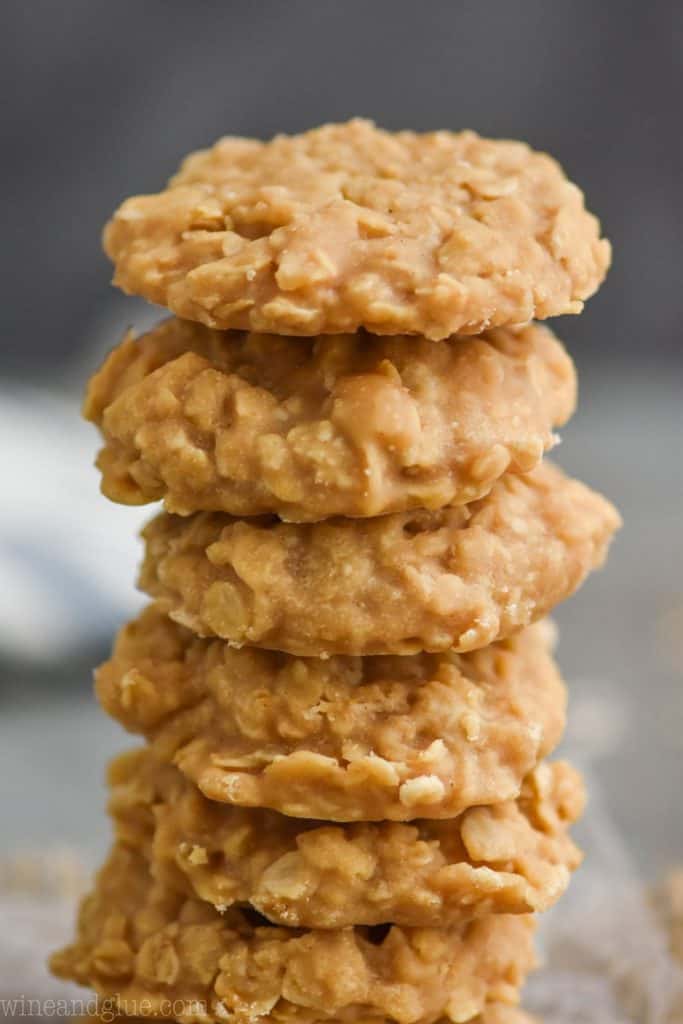 pile of six peanut butter no bake cookies, up close with a dark background