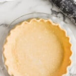 pinterest graphic of overhead of a raw pie crust recipe in a pie plate, says: "the best pie crust recipe simplejoy.com"