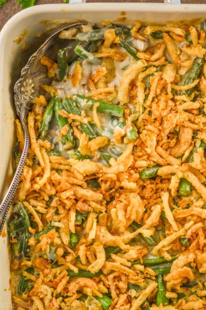 overhead close up of a green bean casserole being dished out of a baking dish