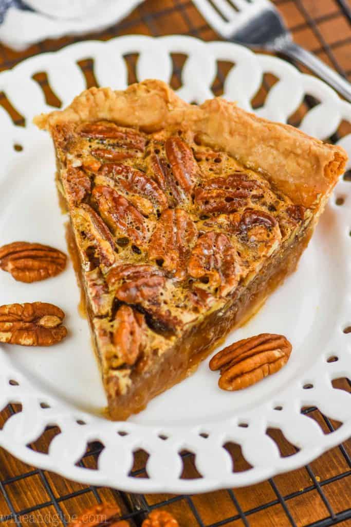 a single slice of easy pecan pie on a fancy white plate