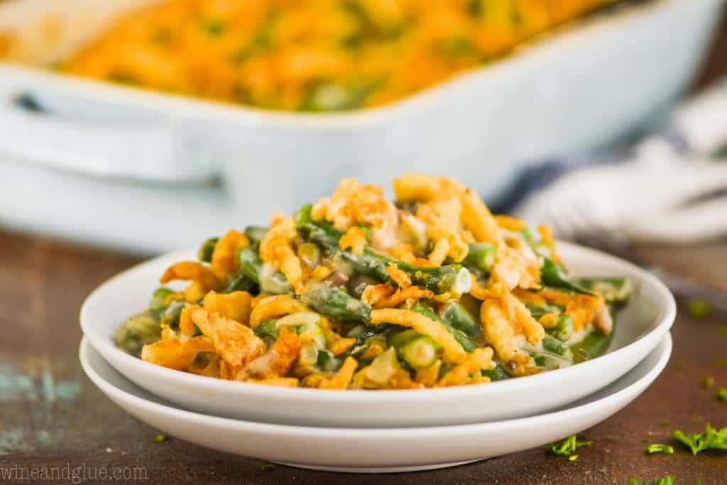 two white plates stacked topped with green bean casserole from scratch