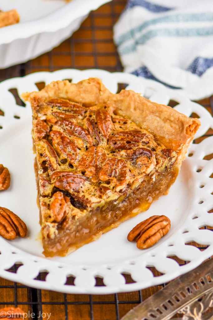 a single slice of easy pecan pie on a fancy white plate