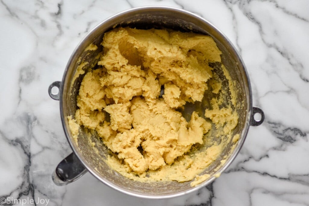 sugar cookie dough in the metal mixing bowl of a stand mixer