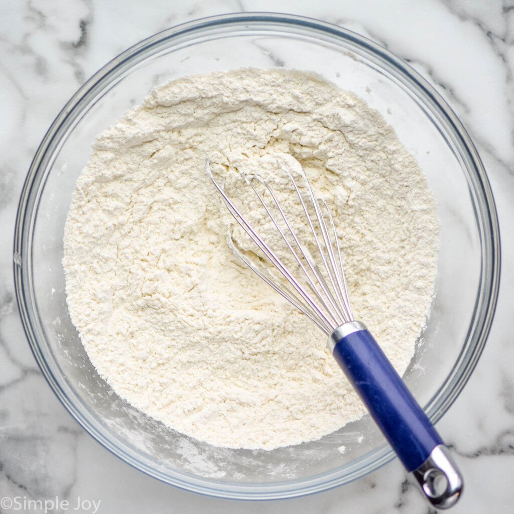 overhead of a bowl of flour, baking powder, and salt to make sugar cookies