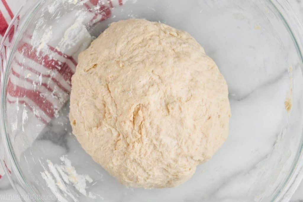an overhead picture of a smooth ball of dough to be made into homemade rolls