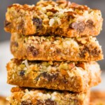 an up close picture of a stack of magic bars with a bite missing from the top one