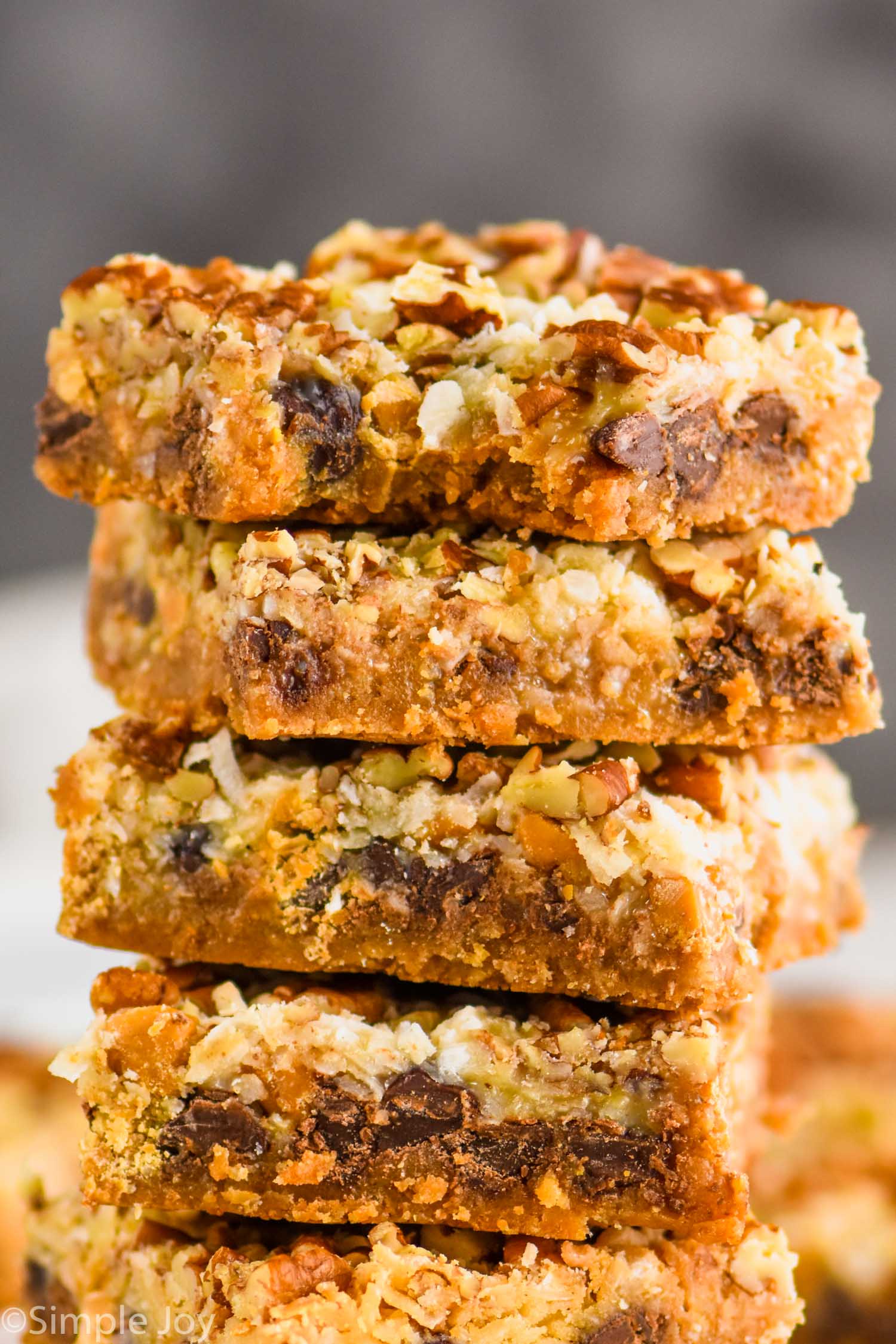 an up close picture of a stack of magic bars with a bite missing from the top one