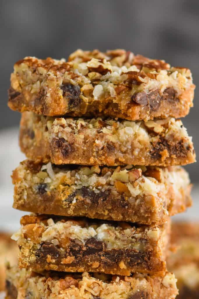 an up close picture of a stack of magic bars with a bite missing from the top one