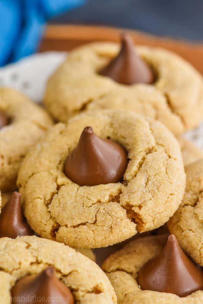 a close up photo of a peanut butter kiss cookie - crisp peanut butter cookie with a Hershey kiss buried into the top