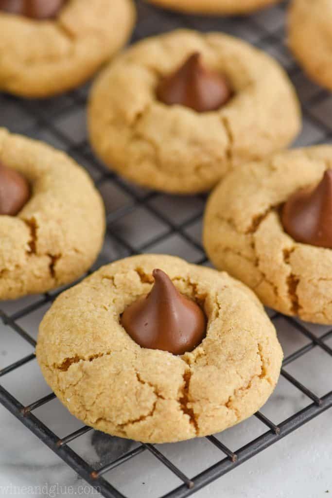 a peanut butter kiss cookie on a wire rack for cooling