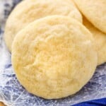 a sugar cookie sitting with other sugar cookies in a pile