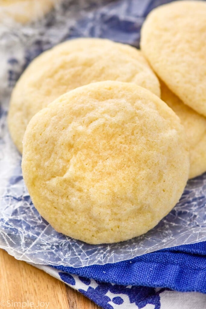 a sugar cookie sitting with other sugar cookies in a pile