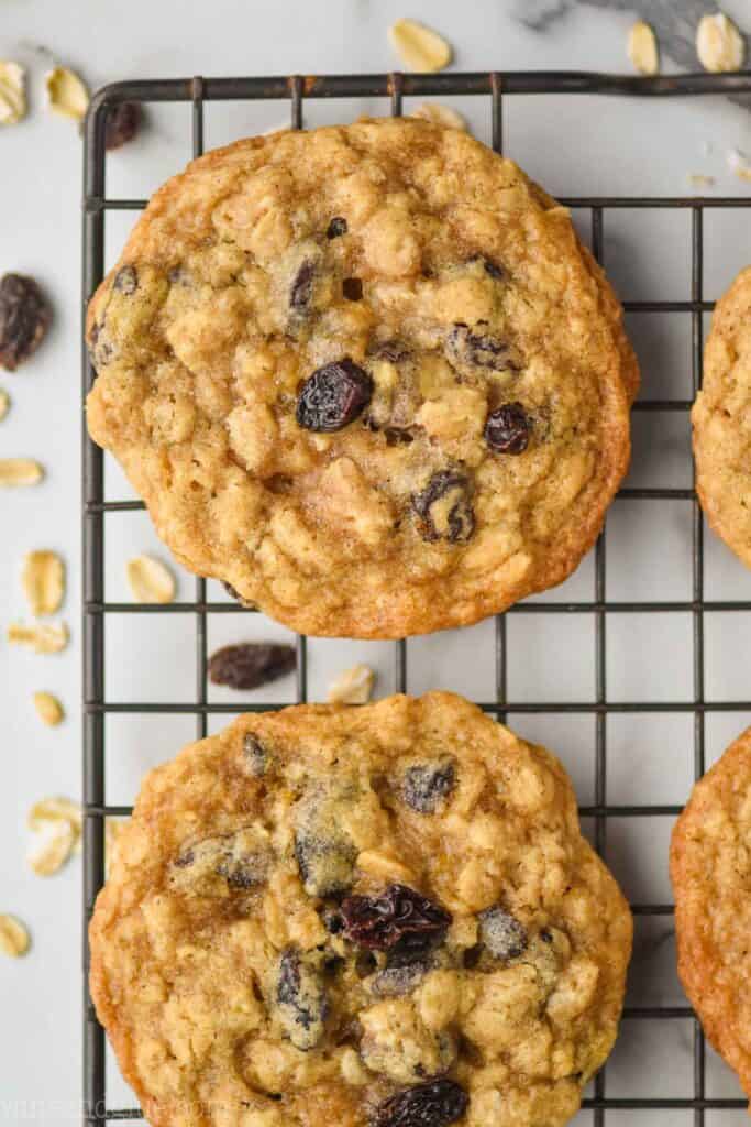 close up overhead view of a chewy oatmeal raisin cookie on a wire cooling rack