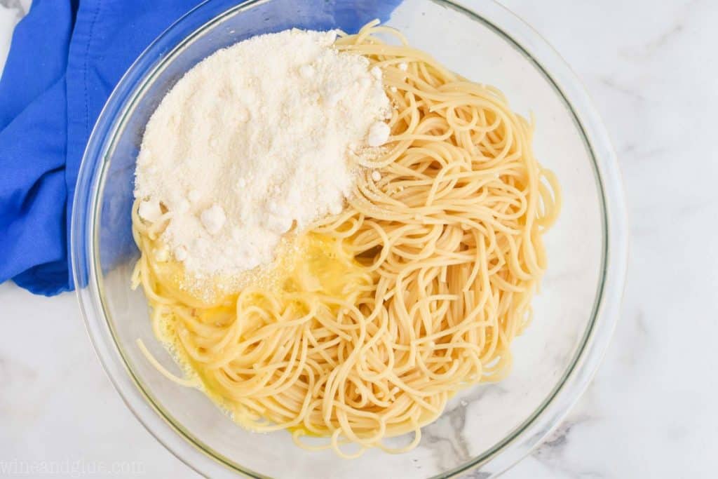 overhead view of a bowl of spaghetti with egg and parmesan
