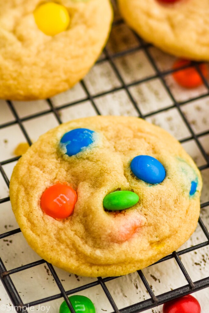 close up of m&m cookie recipe on a wire cooling rack