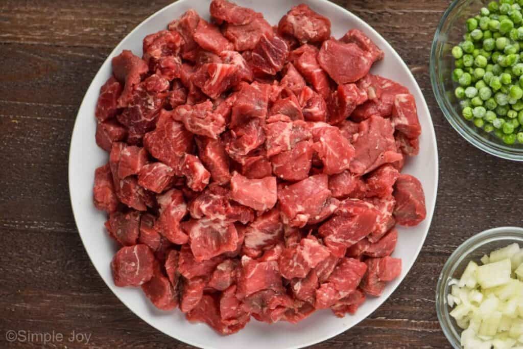 overhead view of a white plate holding beef stew meat