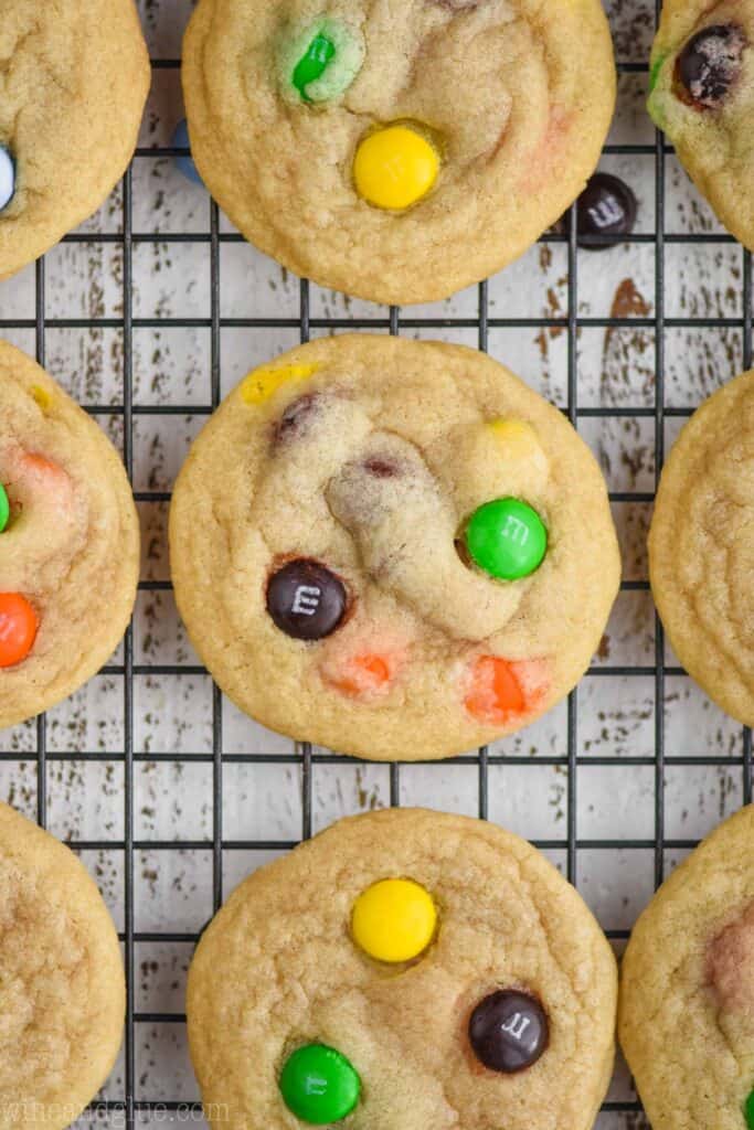 close up overhead photo of an m m cookie on a cooling rack