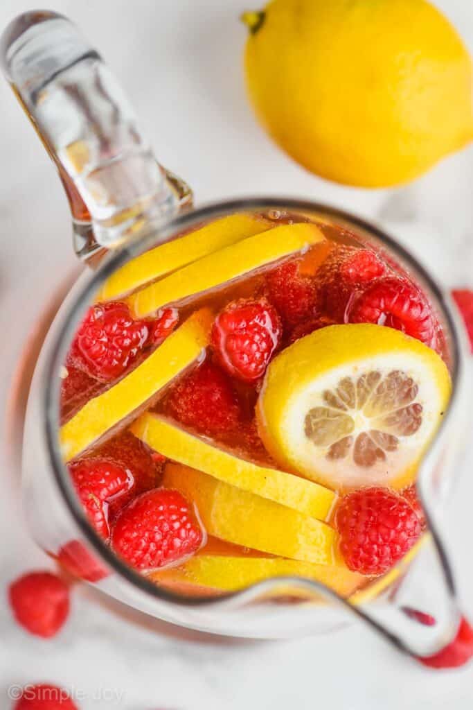 overhead view of a pitcher of rose sangria with fresh lemons and