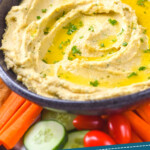 pinterest graphic of a bowl of hummus surrounded by veggies, says: the best homemade hummus simplejoy.com