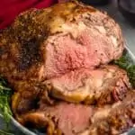 a prime rib cooked and cut on a serving platter