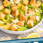 pinterest graphic of a side view of a bowl of Caesar Salad in a large bowl, says: Caesar Salad simplejoy.com