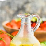 small dressing jar full of greek salad dressing, says: "the best greek dressing simplejoy.com"