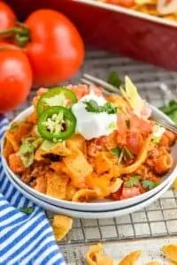 walking taco casserole recipe on two small white plates