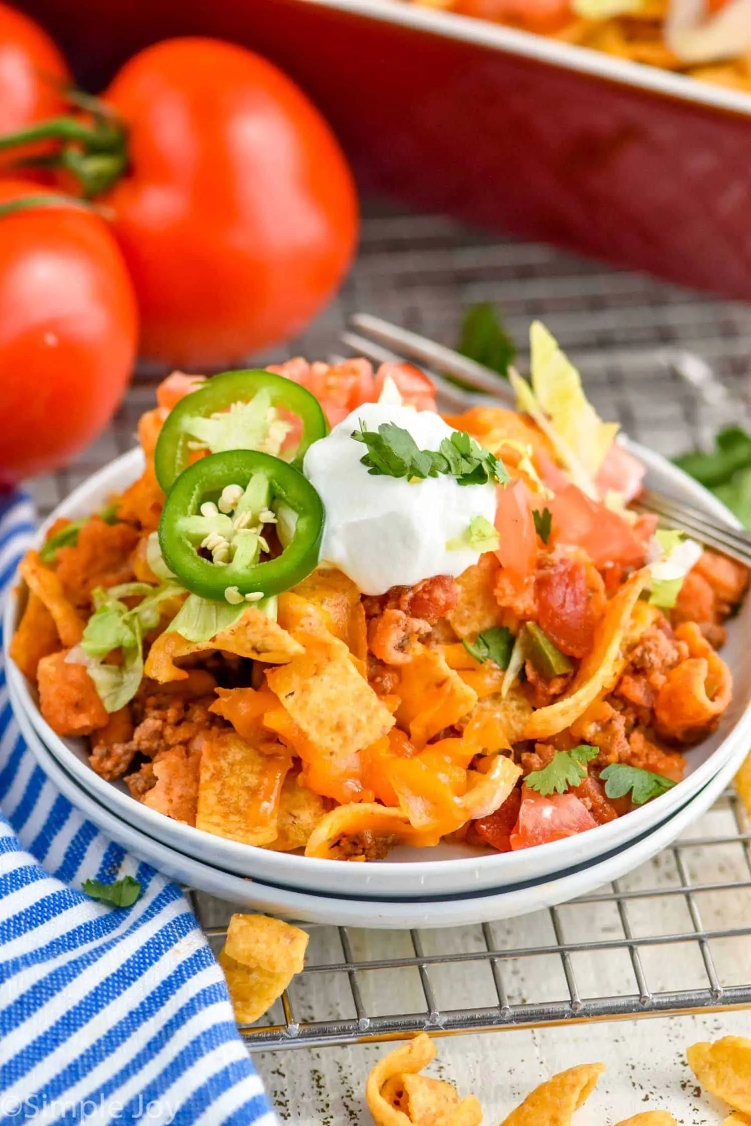 walking taco casserole recipe on two small white plates