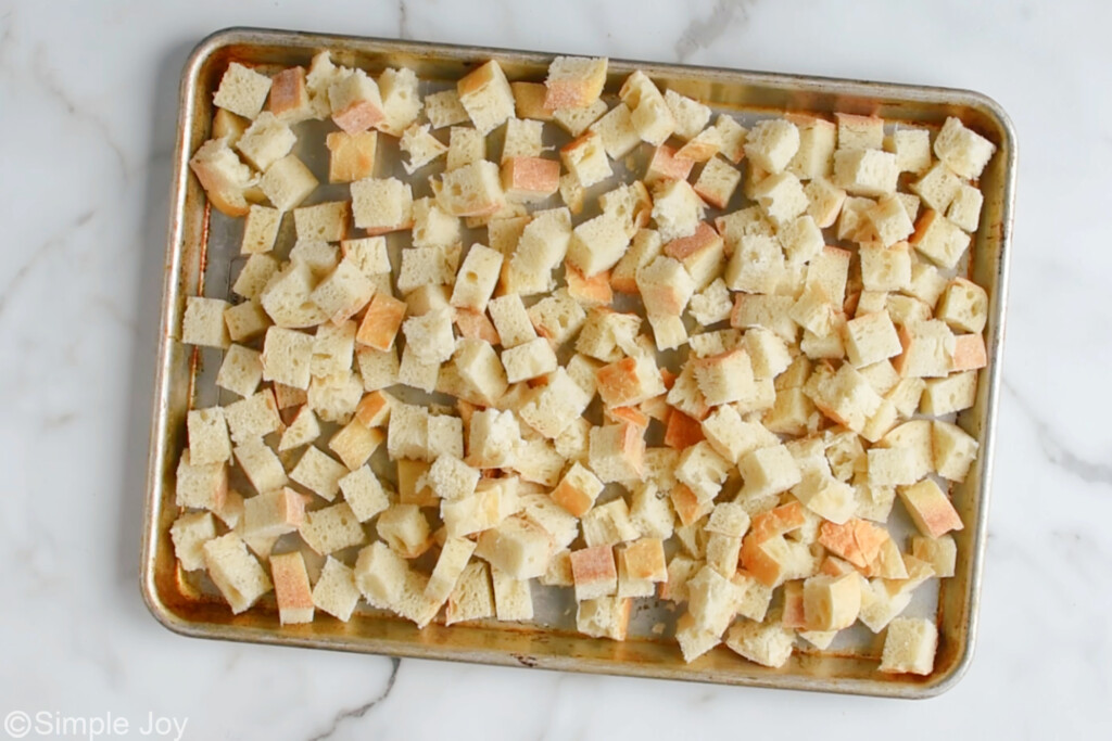 overhead of a rimmed baking sheet filled with bread cubes