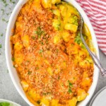 overhead of serving spoon in a casserole dish full of chicken divan