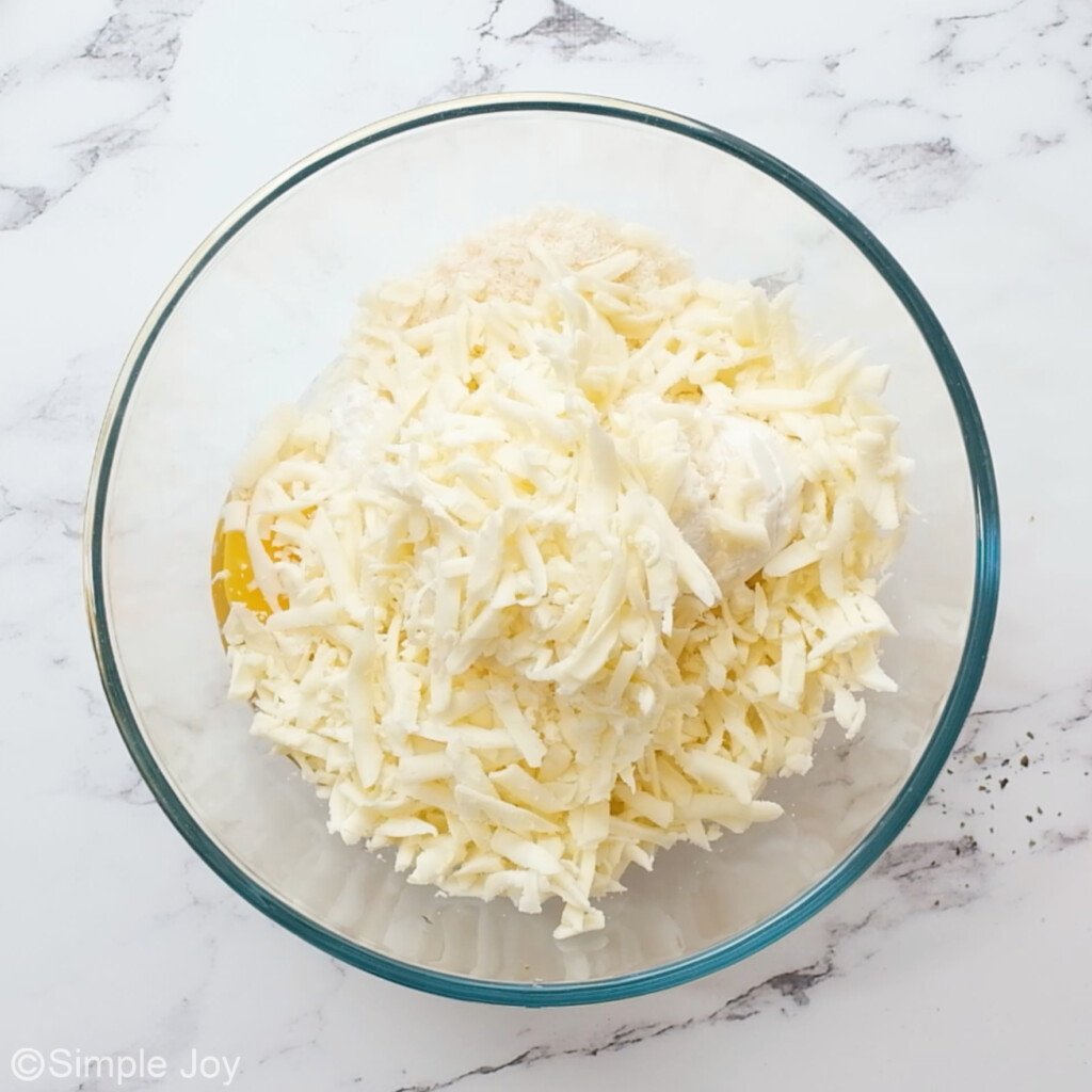 overhead photo of a mixture of cheese, ricotta, and egg