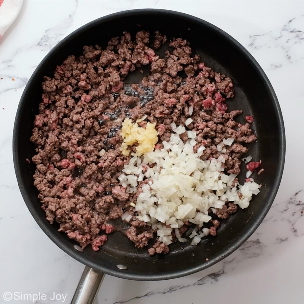 overhead photo of skillet with ground beef, onion, and garlic