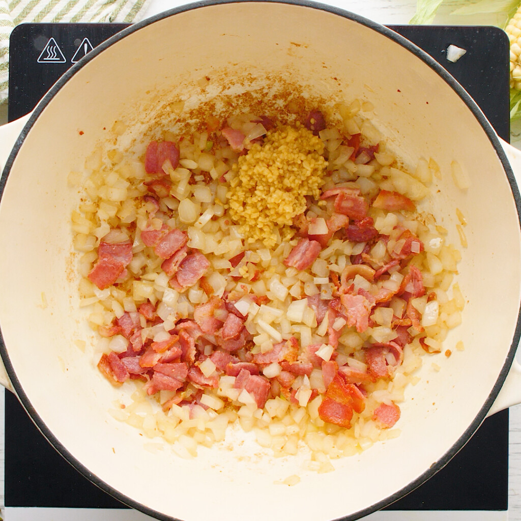 sauteed bacon, onion, and garlic in a skillet