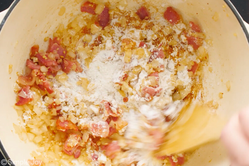 roux being made in a pot with bacon, onions, and garlic