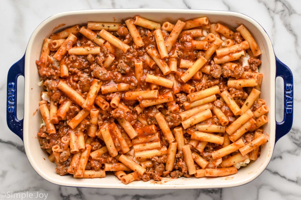 Overhead photo of a baking dish of ingredients for Baked Ziti recipe