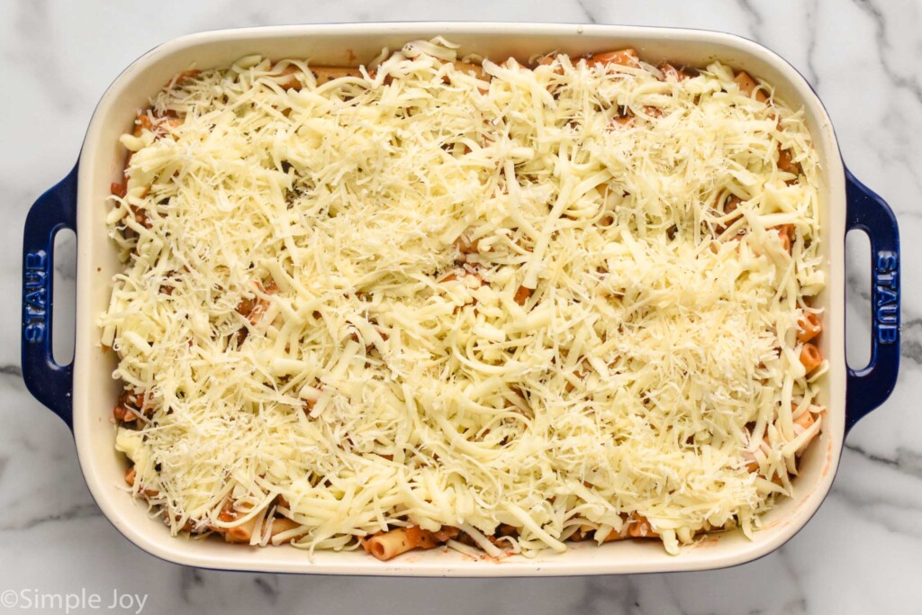 Overhead photo of a baking dish of ingredients for Baked Ziti recipe