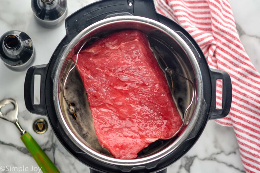 Overhead photo of raw corned beef in an instant pot for Instant Pot Corned Beef recipe